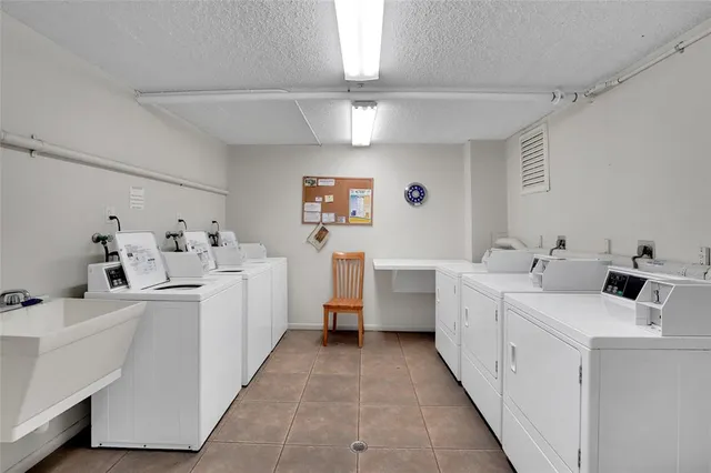 a view of a kitchen with a sink washer and dryer