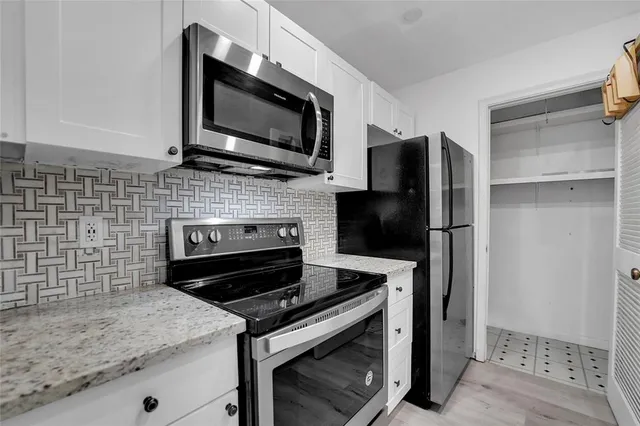 a kitchen with a stove microwave and refrigerator