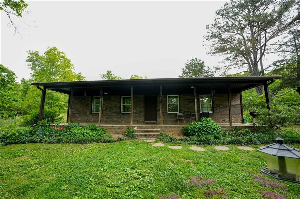 253 Dry Creek Road Cedartown, GA 30125 - Photo 1 of 1 a view of a house with a yard and plants