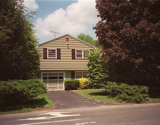 3926 Old Town Road Bridgeport, CT 06606 - Photo 1 of 1 a front view of a house with a garden
