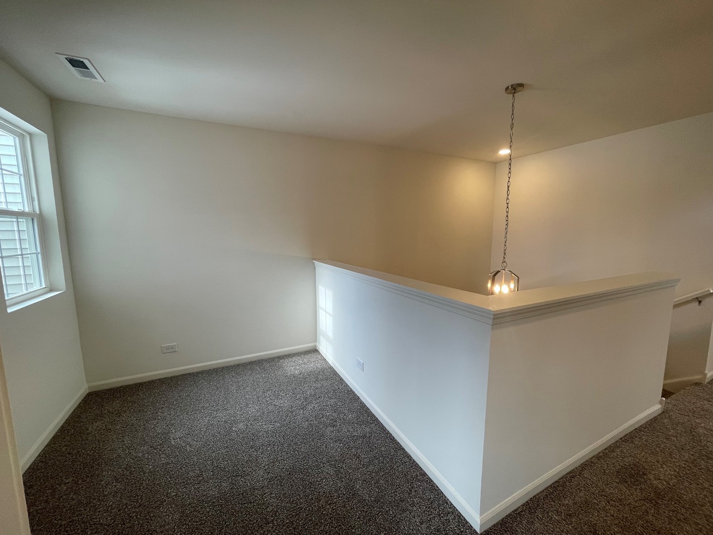 786 Westbury Drive Cary, IL 60013 - Photo 12 of 31 an empty room with stairs and wooden floor