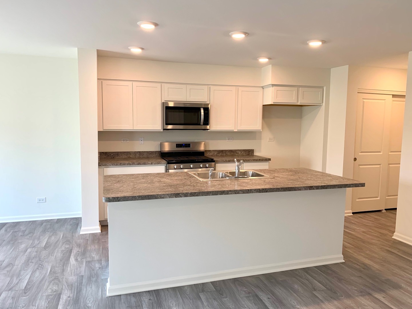786 Westbury Drive Cary, IL 60013 - Photo 3 of 31 a kitchen with stainless steel appliances a sink stove refrigerator and white cabinets with wooden floor