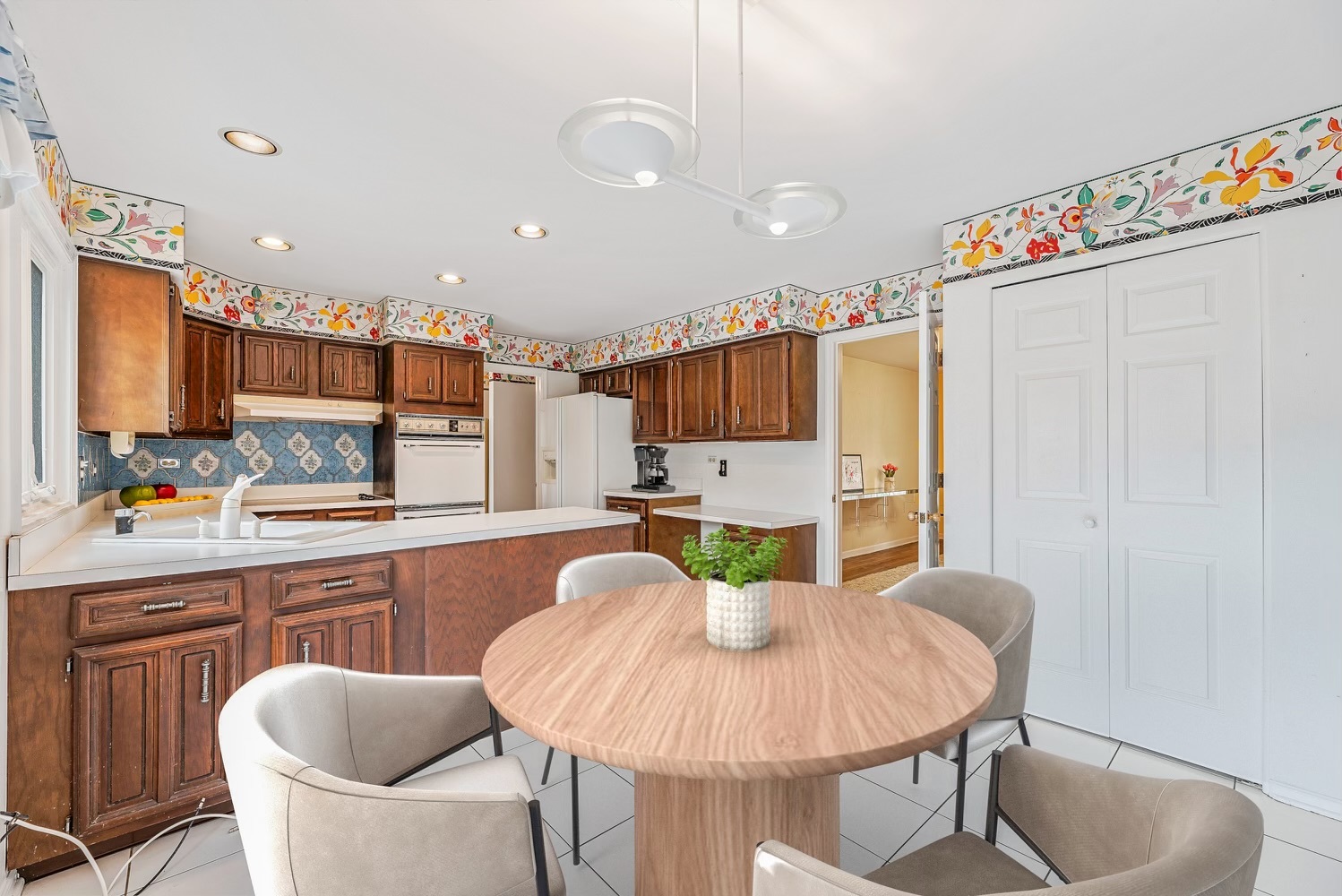3210 Old Mill Road Northbrook, IL 60062 - Photo 13 of 41 a kitchen with stainless steel appliances a dining table chairs and a refrigerator