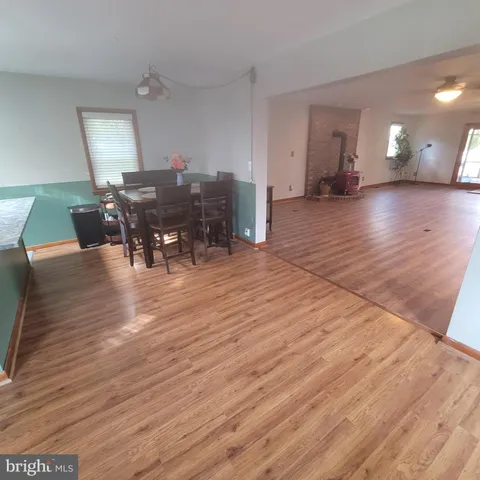 a view of a dining room with furniture and wooden floor