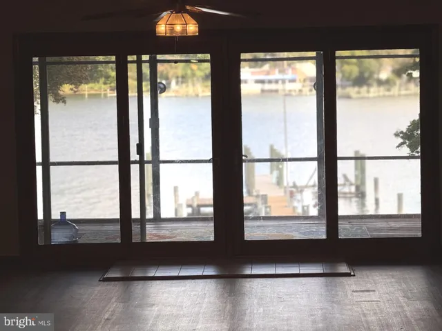 a living room with a large window and floor to ceiling window