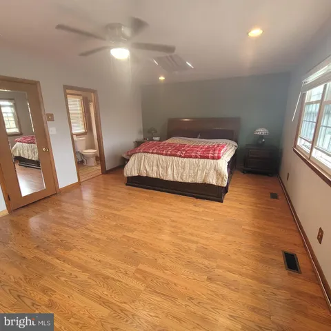 a bedroom with a bed and a large window