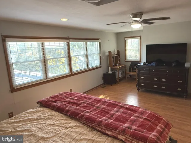 a spacious bedroom with a large bed and a flat screen tv