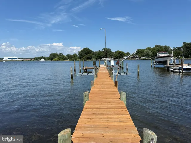 a view of residential houses with outdoor space and lake view