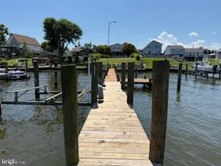 a view of a roof deck with table and chairs a barbeque