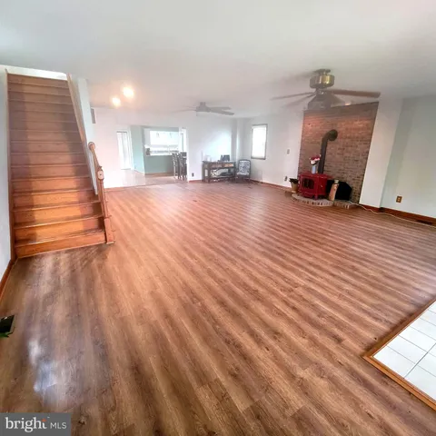 a view of an empty room and wooden floor