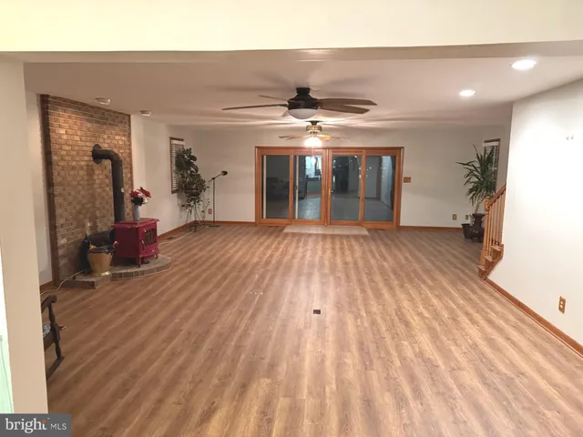 a view of a room with wooden floor and furniture