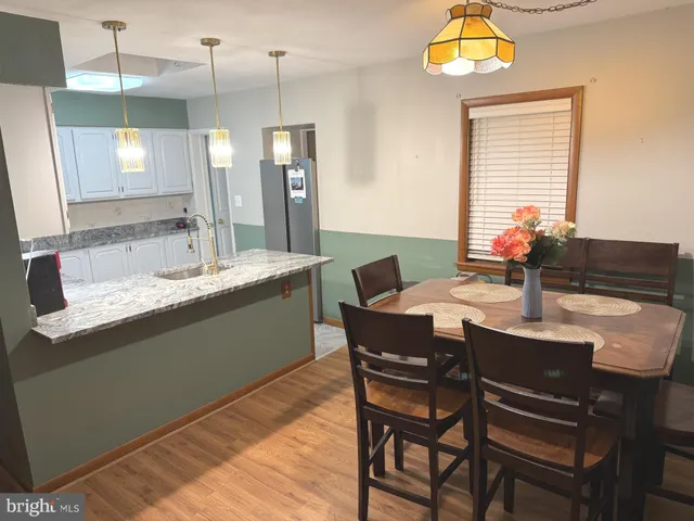 a dining room with a table and chairs