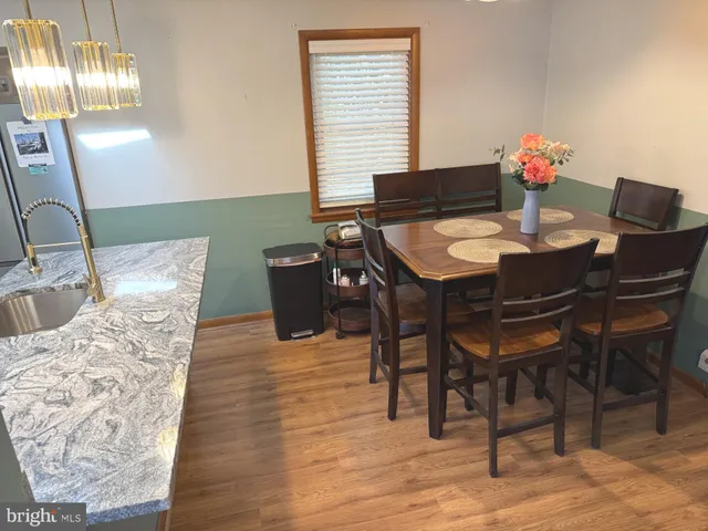 a view of a dining room with furniture and chandelier