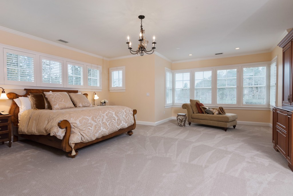 2 Stonegate Lane Dover, MA 02030 - Photo 16 of 28 a spacious bedroom with a bed and a chandelier