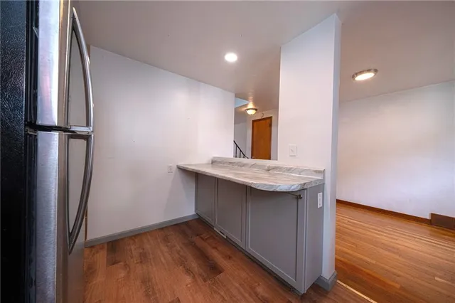 a kitchen with stainless steel appliances granite countertop a refrigerator and a sink