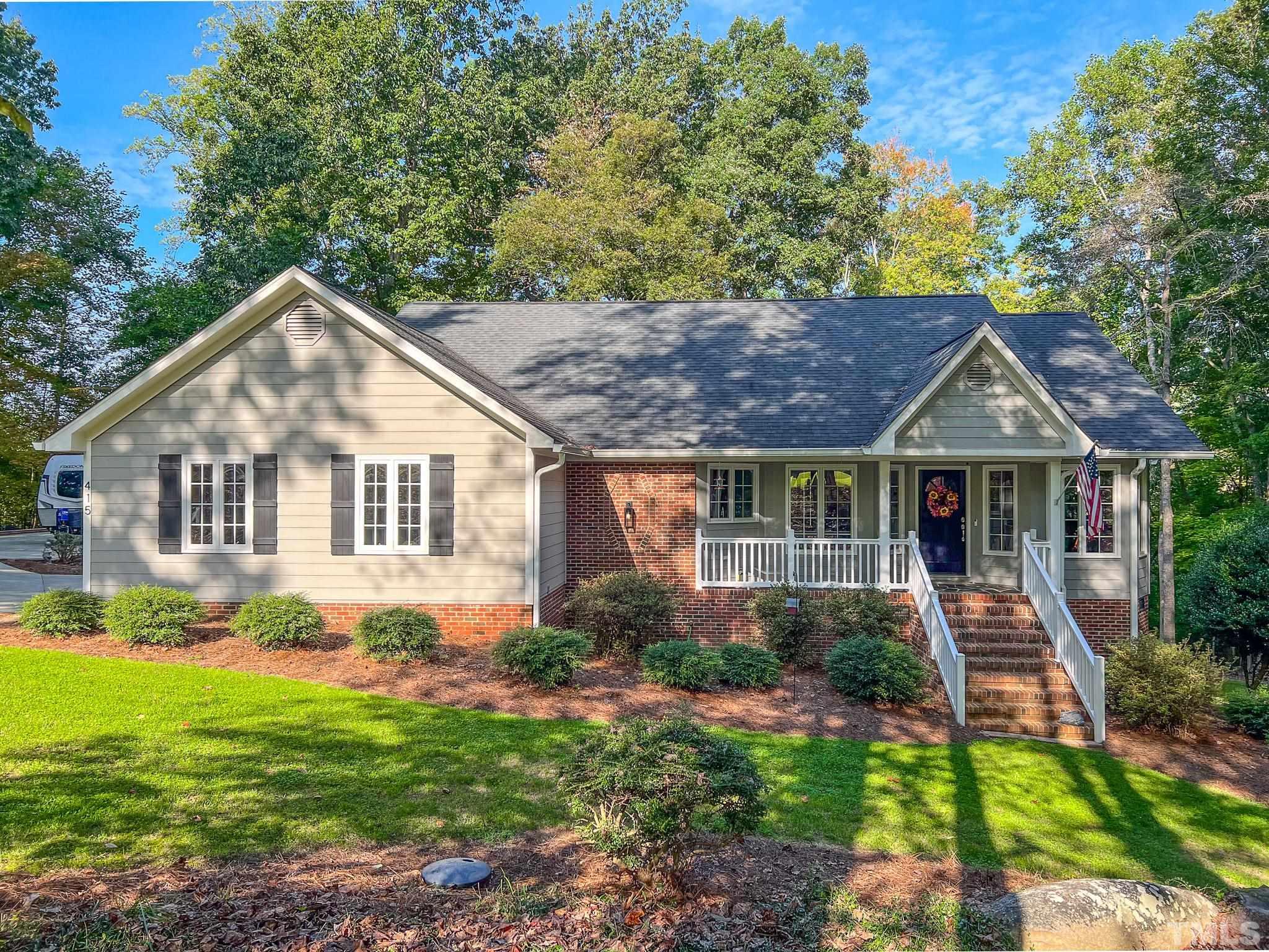 a front view of house with yard and green space