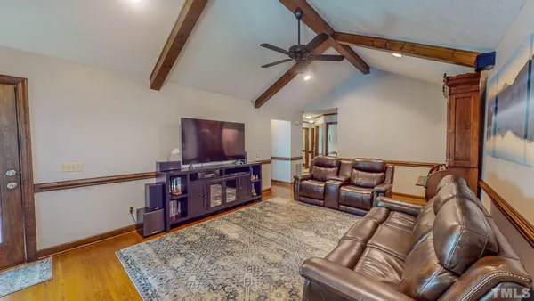 a dining room with furniture a chandelier and window