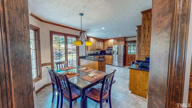 a view of a dining room with furniture window and outside view