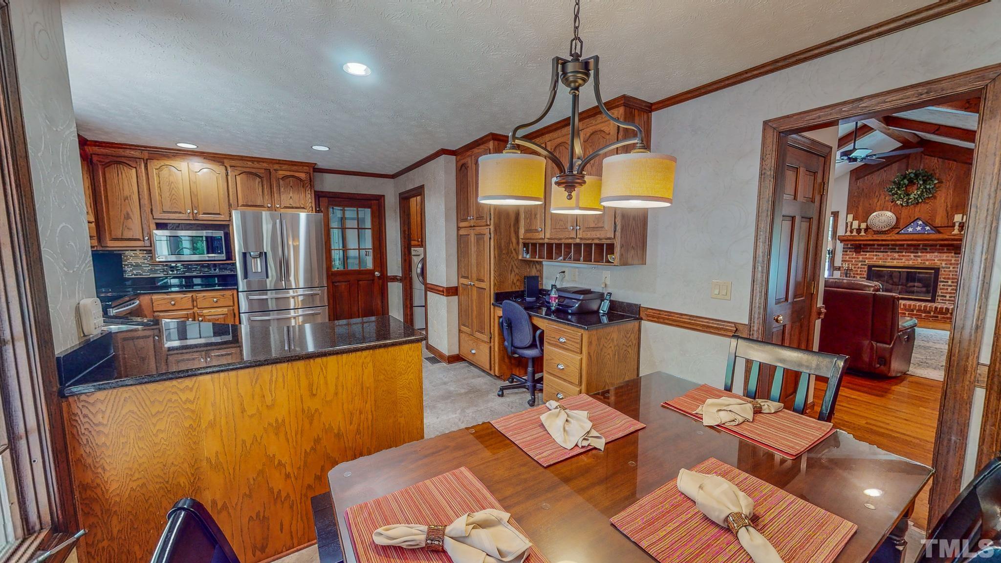 415 North Ridge Circle Roxboro, NC 27574 - Photo 17 of 59 a view of a dining room with furniture a chandelier and wooden floor