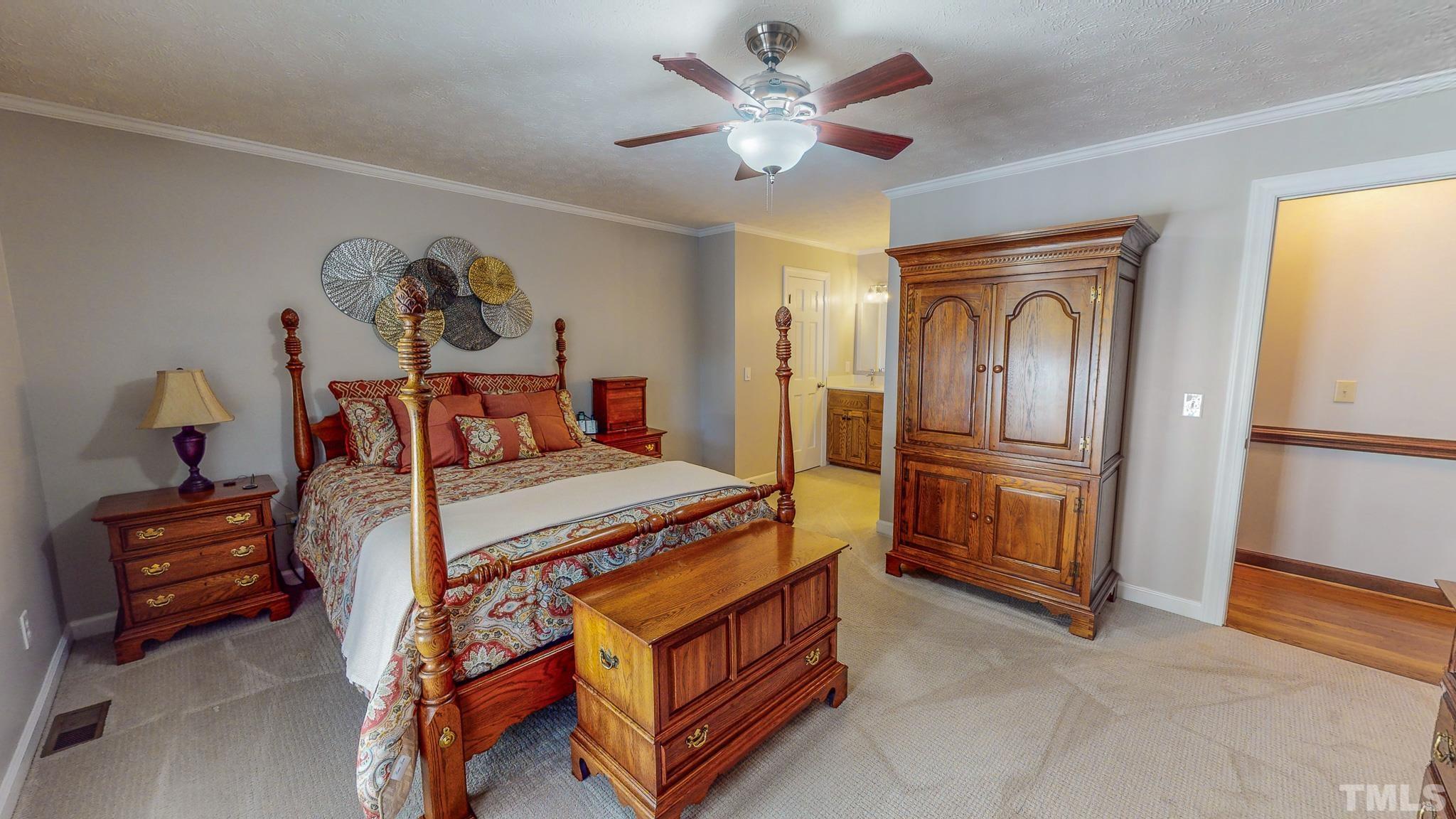 415 North Ridge Circle Roxboro, NC 27574 - Photo 28 of 59 a bedroom with a bed and a chandelier