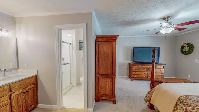 an aerial view of residential house with outdoor space and trees all around