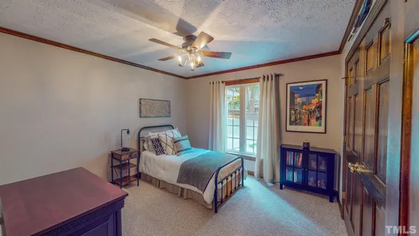 a bedroom with a bed and a chandelier