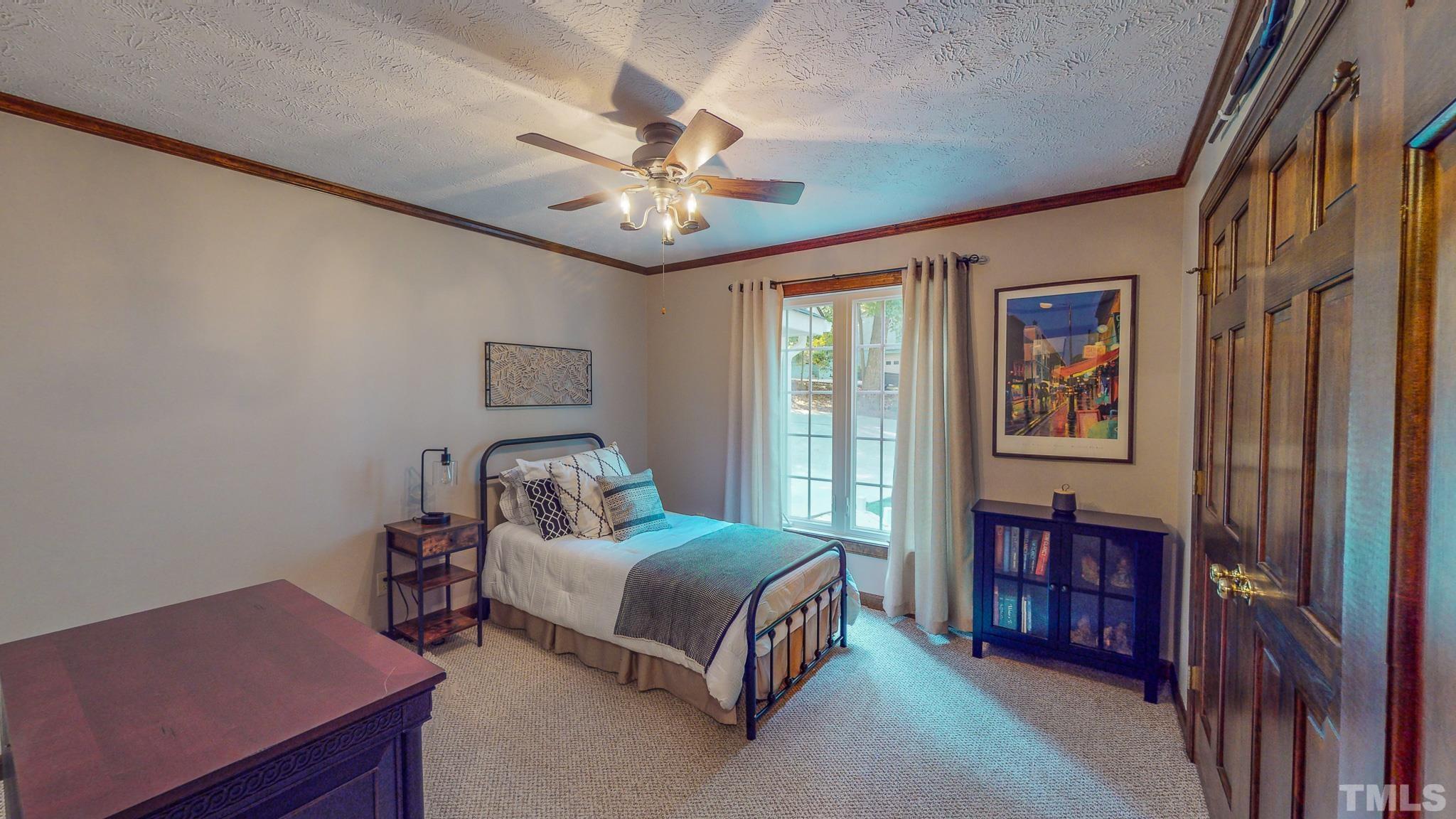 415 North Ridge Circle Roxboro, NC 27574 - Photo 38 of 59 a bedroom with a bed and a chandelier