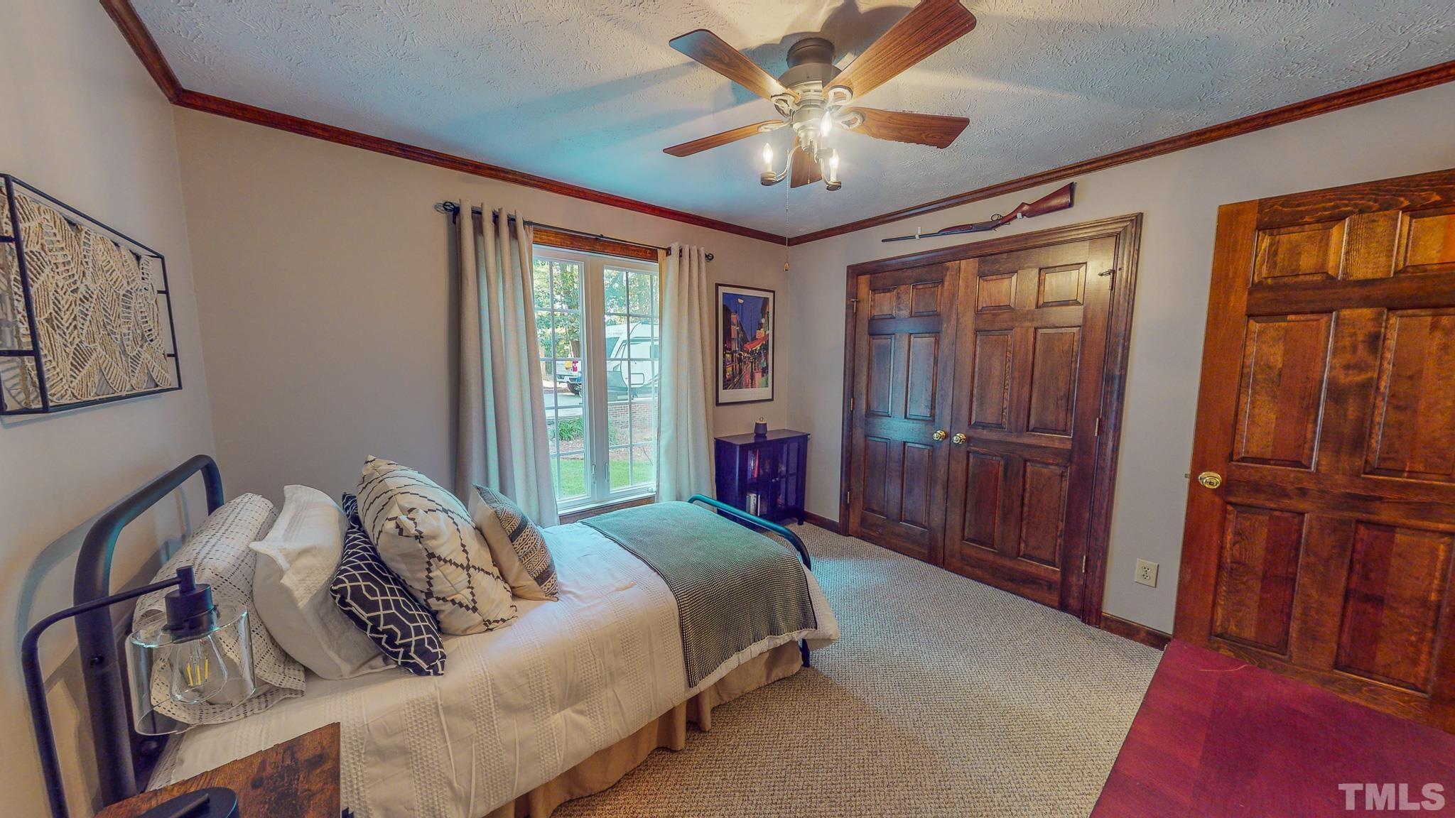 415 North Ridge Circle Roxboro, NC 27574 - Photo 40 of 59 a bedroom with a large bed and a chandelier