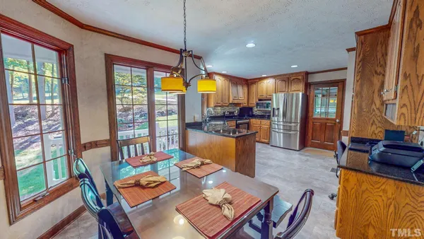 a living room with furniture a flat screen tv and a large window