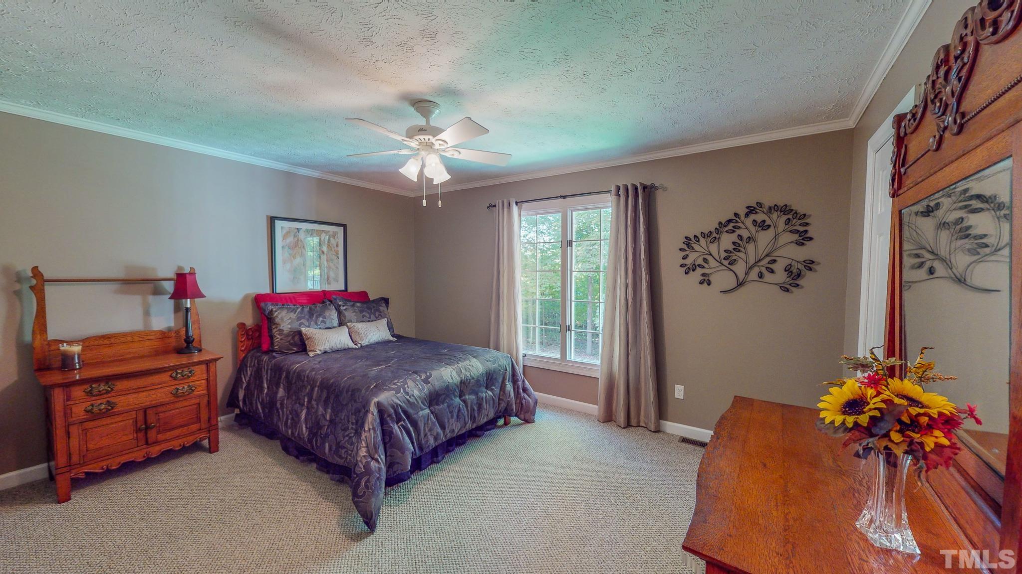 415 North Ridge Circle Roxboro, NC 27574 - Photo 41 of 59 a bedroom with a bed and a chandelier