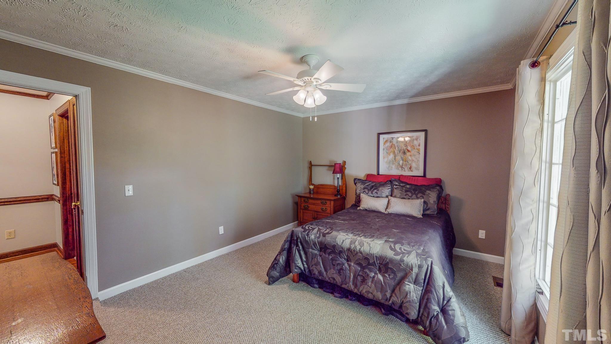 415 North Ridge Circle Roxboro, NC 27574 - Photo 42 of 59 a bedroom with a bed and a chandelier