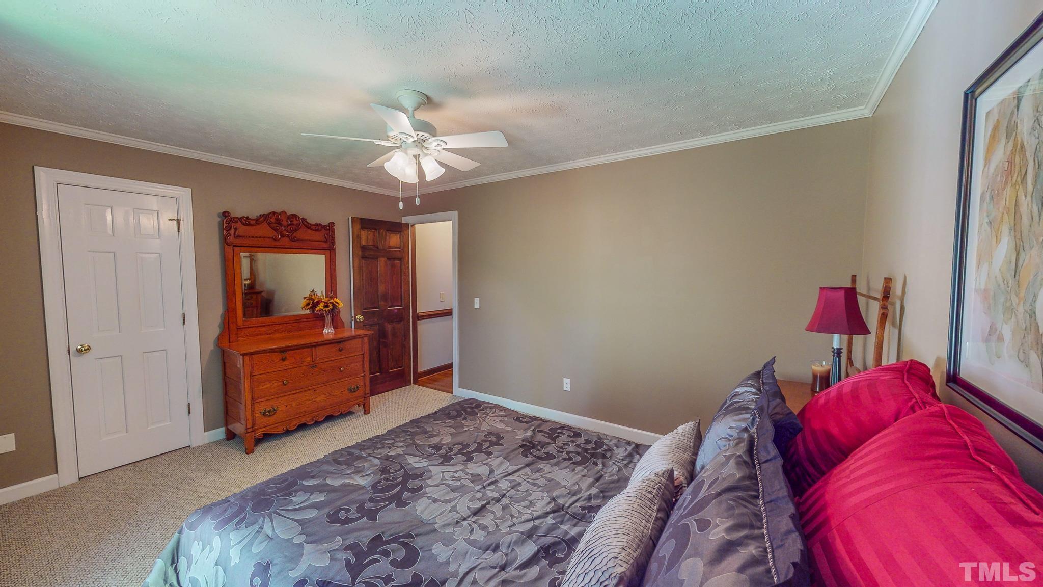 415 North Ridge Circle Roxboro, NC 27574 - Photo 43 of 59 a bed room with a bed and a chandelier