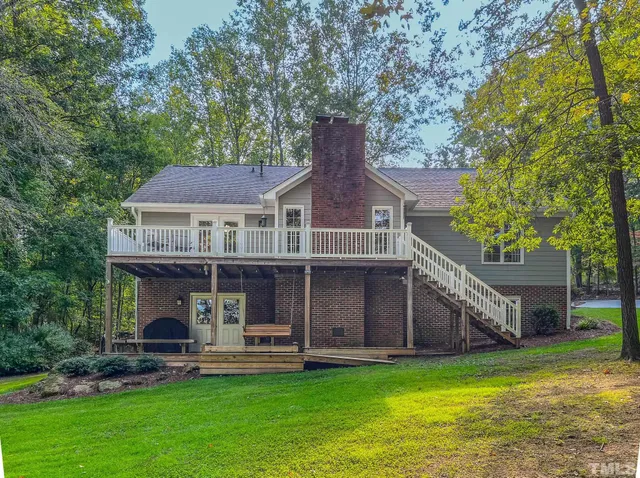a front view of a house with a garden and porch