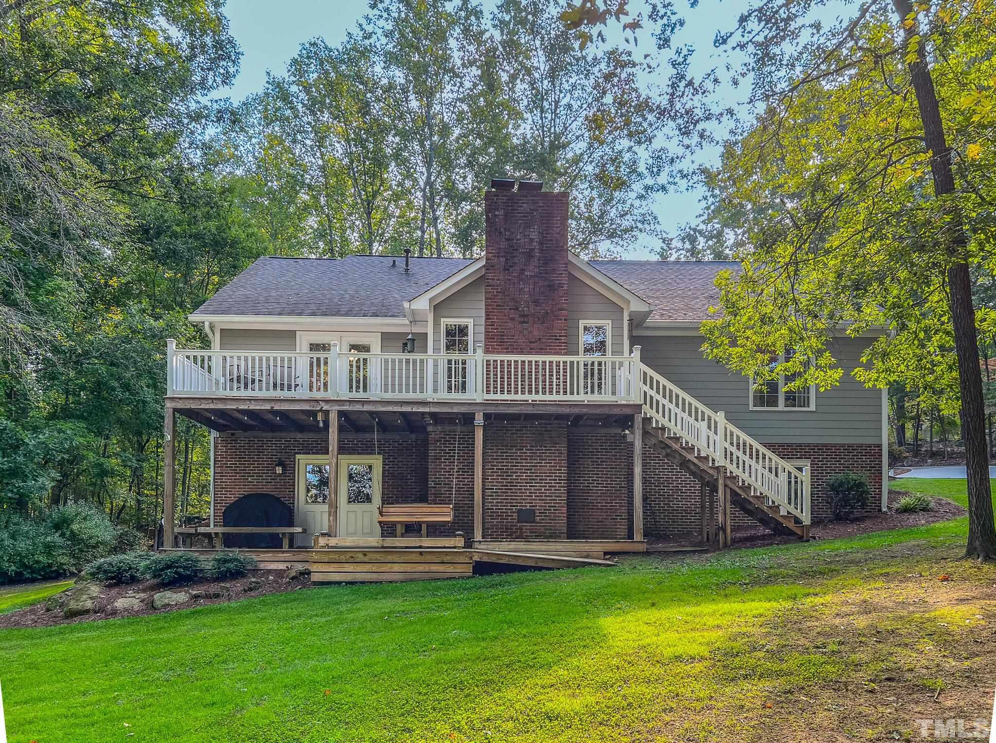 415 North Ridge Circle Roxboro, NC 27574 - Photo 5 of 59 a front view of a house with a garden and porch