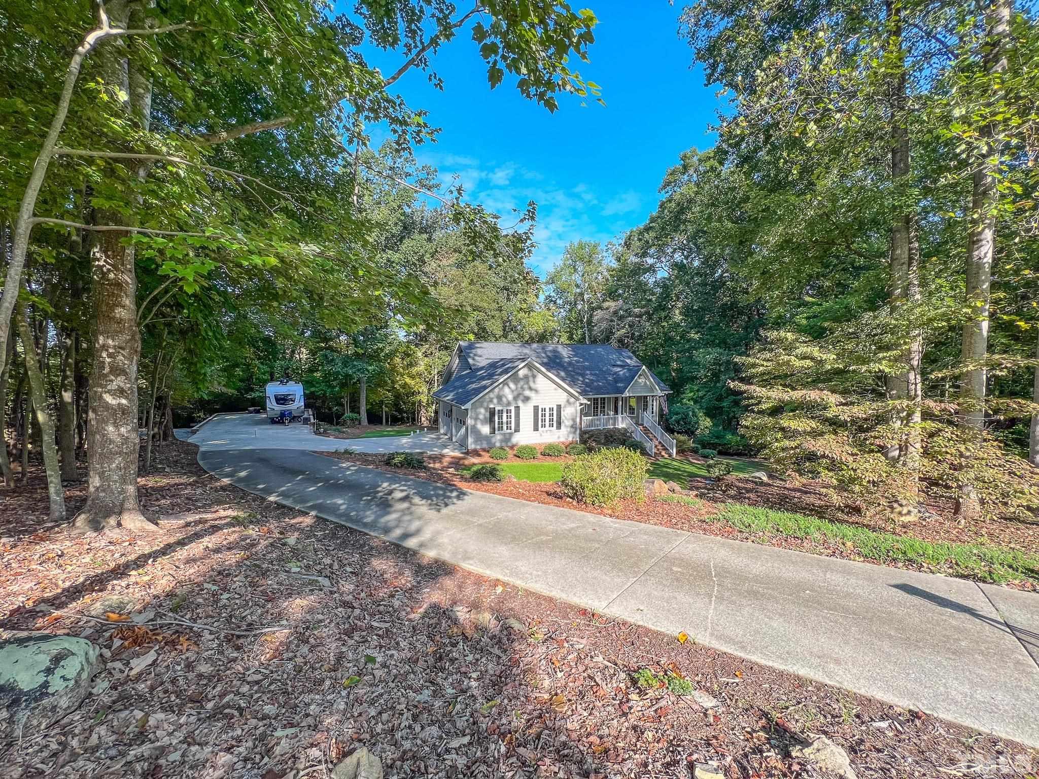 415 North Ridge Circle Roxboro, NC 27574 - Photo 56 of 59 a view of a yard with plants and large trees