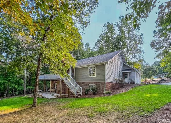 a front view of house with yard and green space