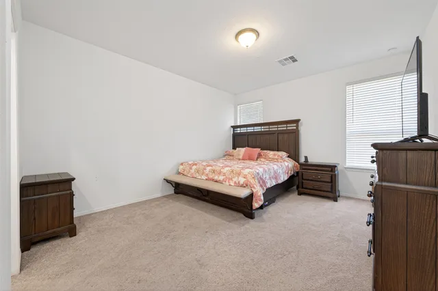 a bedroom with a bed and a cabinets