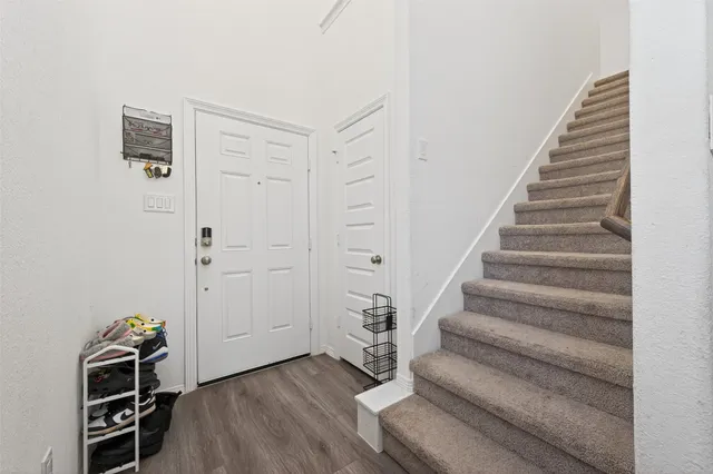 a view of entryway with stairs and wooden floor