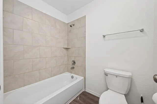 a bathroom with a toilet a sink and bathtub