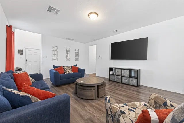 a living room with furniture and a flat screen tv