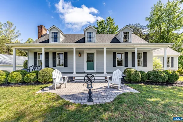 a front view of a house with yard and green space