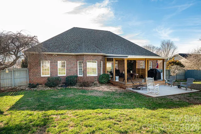a view of a house with backyard porch and sitting area