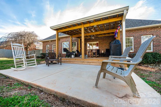 a view of a house with backyard porch and sitting area