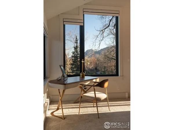 a view of a room with a table and chairs