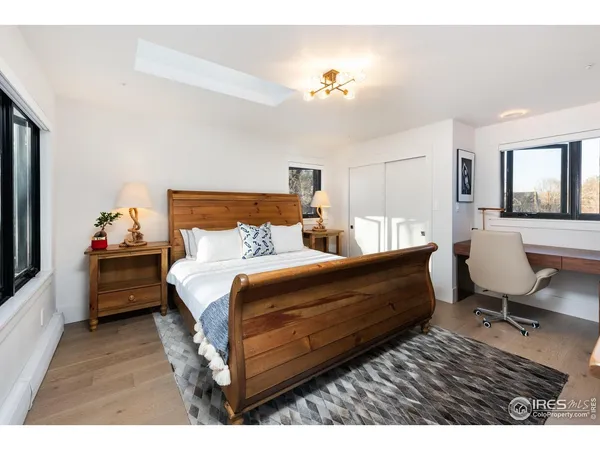 a bed room with a bed window and a chair