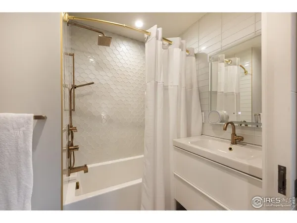 a bathroom with a shower and a sink