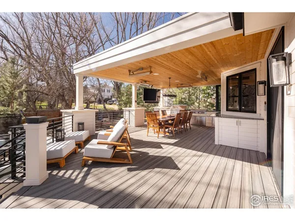 a view of a chairs and table in patio with a barbeque