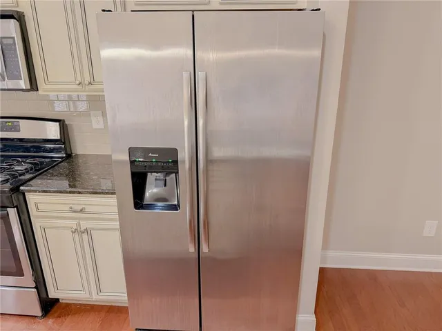 a kitchen with a refrigerator and a stove