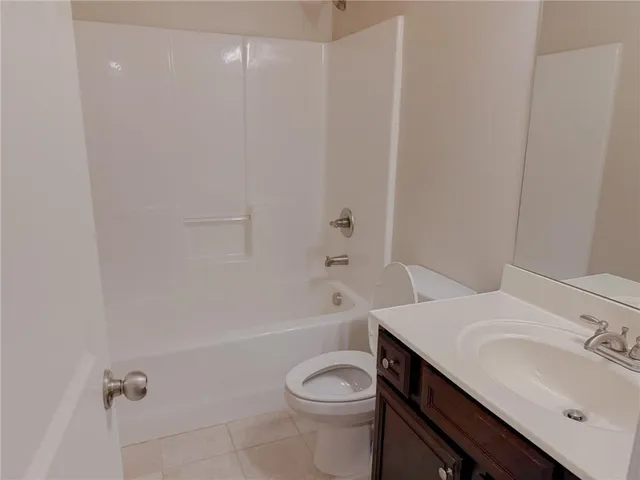 a bathroom with a sink toilet vanity and bathtub