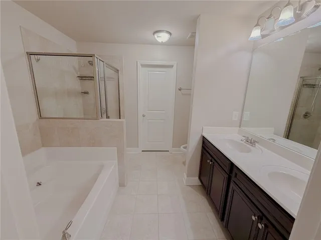 a bathroom with a tub sink and mirror
